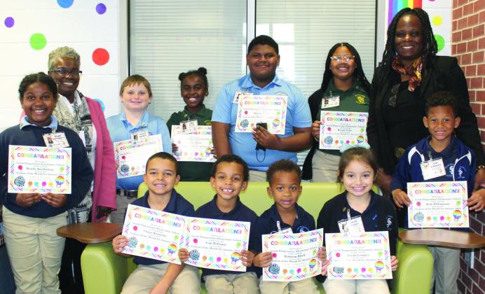 SPES JANUARY STUDENTS OF THE MONTH - Pictured in the back row, from left: Brielle Barthelemy, Mrs. Tonya Redmond (SPES Assistant Principal), Preston Hamilton, Cailey Ancar, Dracen Sylve, Kynsli Tyler, Dr. Stacey-Ann Barrett (SPES Principal) and Kole Williamson. Front row (sitting): Chase Bonnette, Isah Williams, Kamran Black and Leyah Longley.