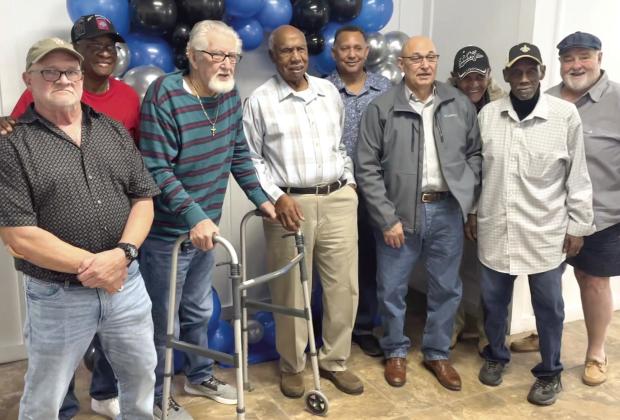 Charlie Wilson (fourth from the left) poses with old friends and coworkers during his retirement party.