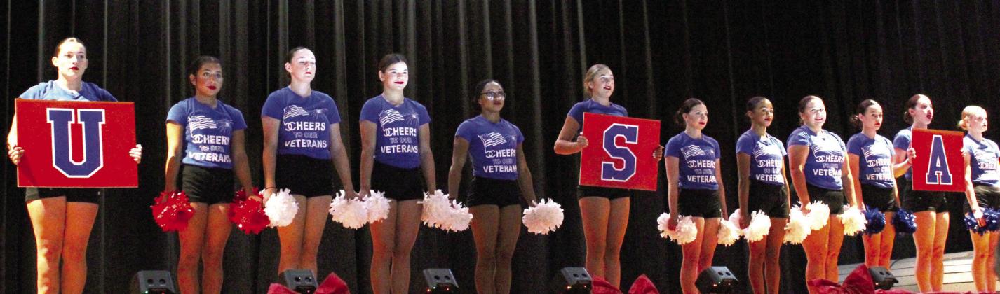 The Cardinalettes performing on the auditorium stage for the veterans.